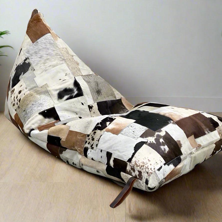 Boho cowhide bean bag cover with triangular patchwork in cream, coffee, chocolate, and brindle tones.