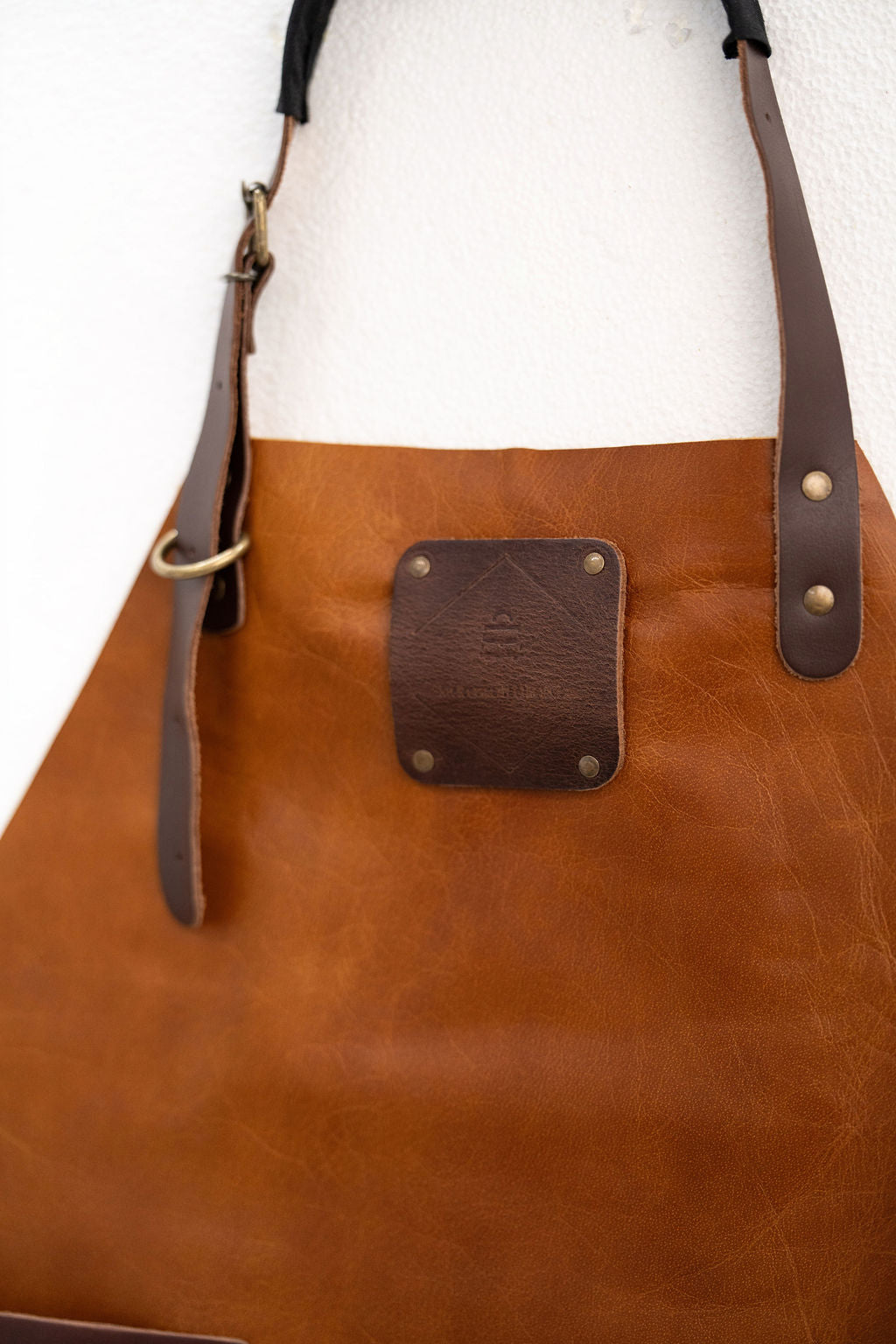 Full coverage saddle brown leather apron for kitchen and craft work