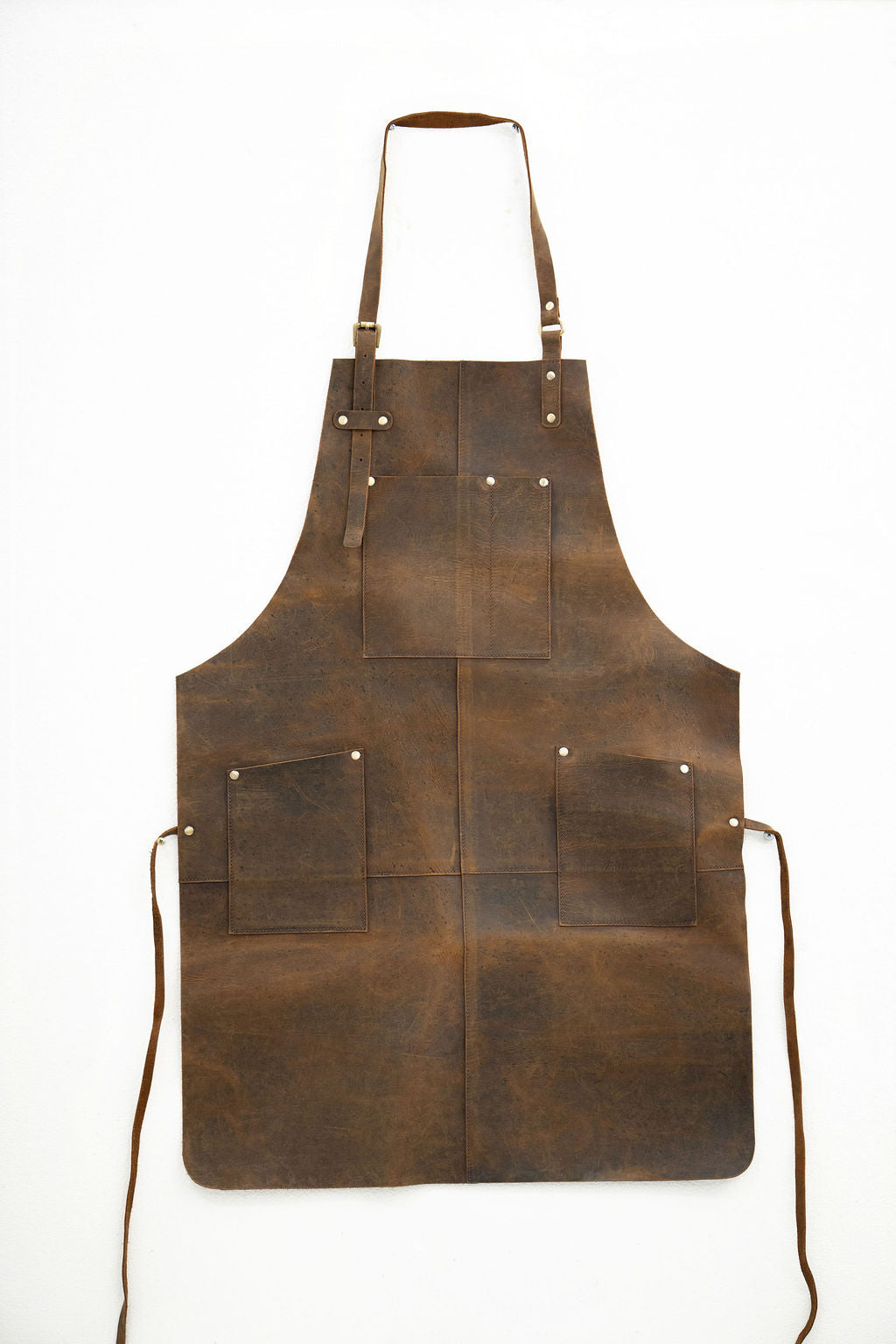 Handcrafted vintage brown leather apron with front pockets for artisans