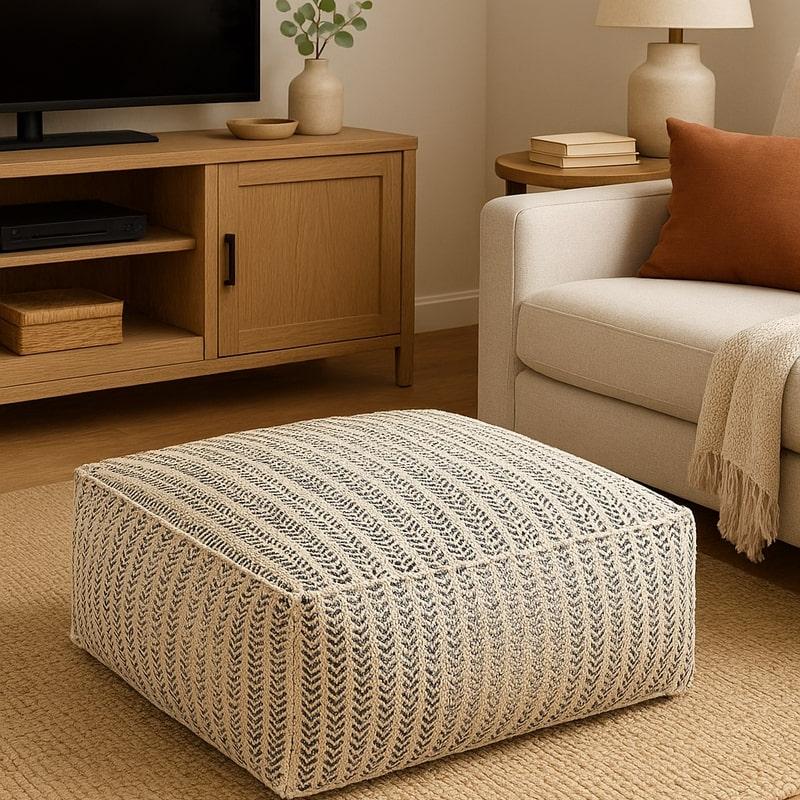 Handwoven cotton ottoman pouf with neutral-toned striped weave, perfect for modern boho or coastal decor.