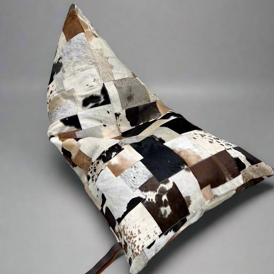 Boho triangular cowhide bean bag cover with patchwork of cream, coffee, chocolate, and brindle tones.