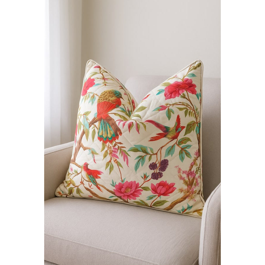 Handmade quilted cotton cushion cover with vibrant floral and bird of paradise design on a cream background.