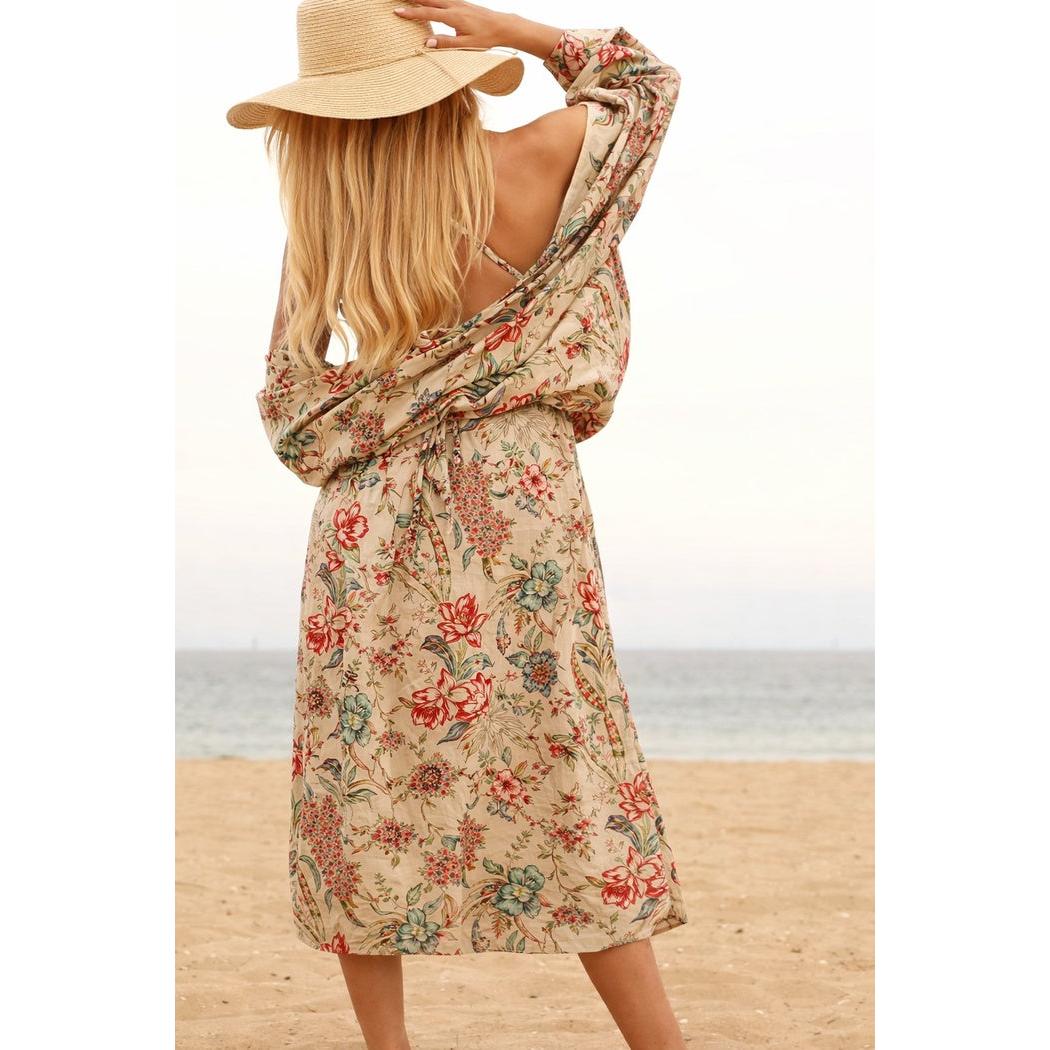 Beige cotton kimono with red and blue floral print, worn by a woman on a beach.