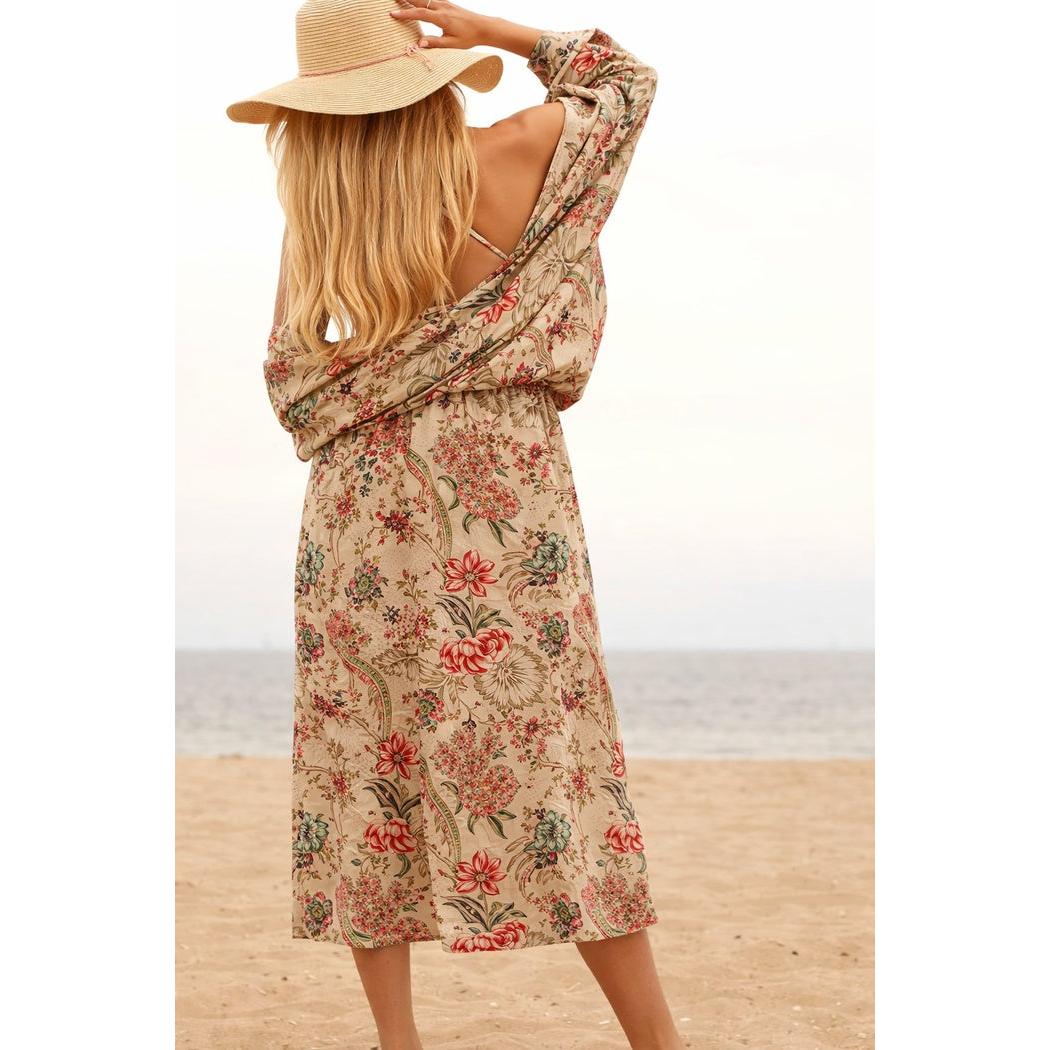 Beige cotton kimono with floral print, worn by a woman on a beach, showing the back.