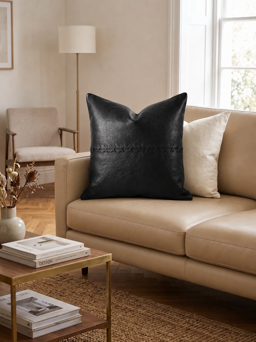 Handcrafted leather cushion cover in tan color with black cross detailing for bohemian home styling.