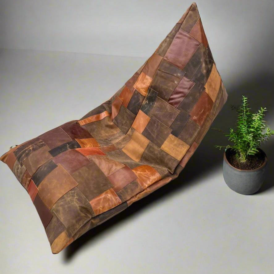 Vintage brown patchwork cowhide leather bean bag cover with a small green plant.