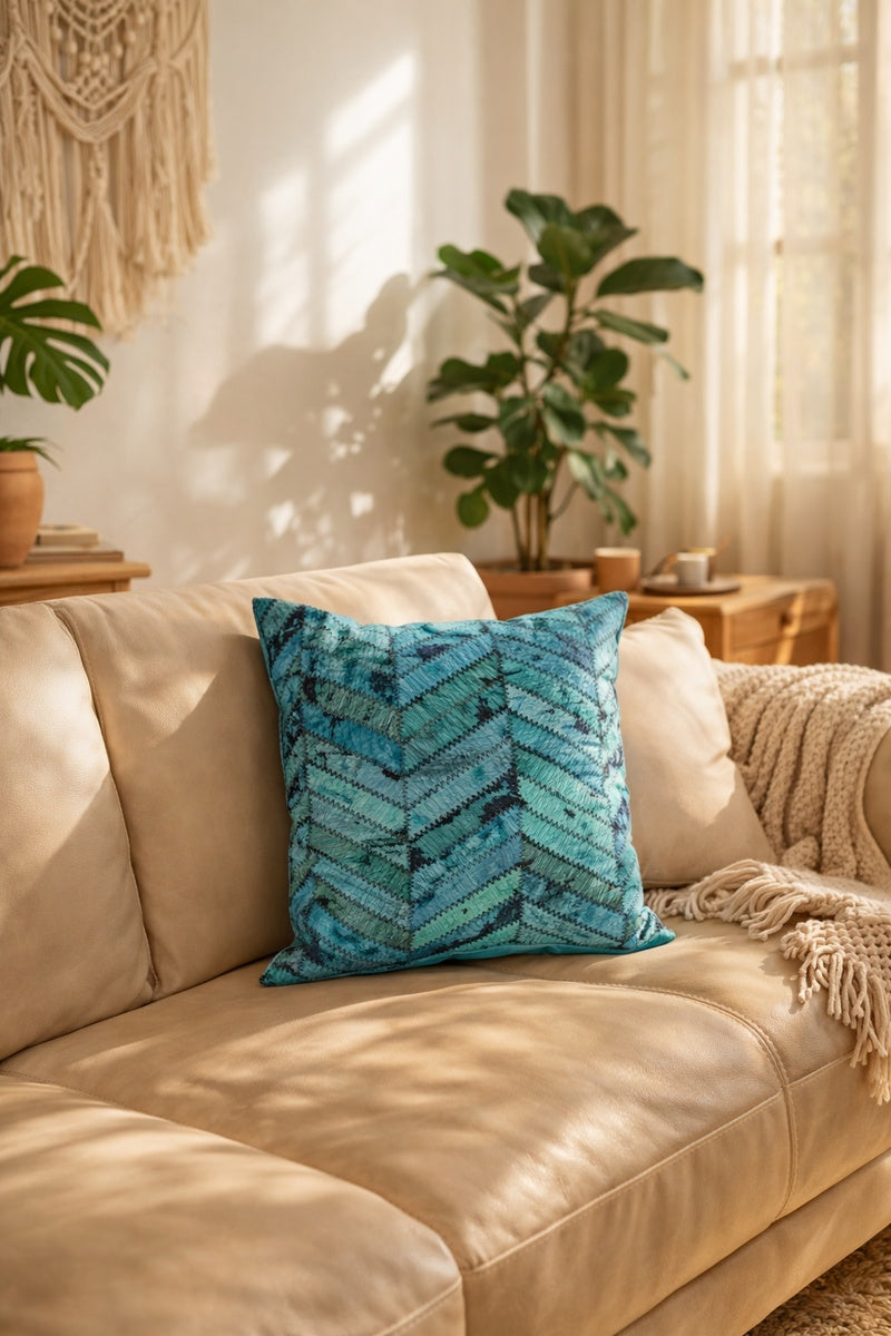 Teal hair-on-hide cushion cover with artisan patchwork detail