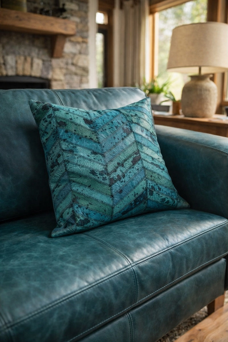 Close up of teal cowhide patchwork cushion showing natural texture