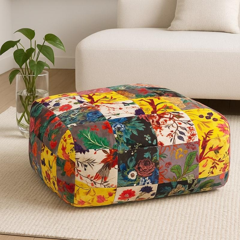 Boho velvet patchwork ottoman with vibrant floral and bird patterns in yellow, red, blue, and green.