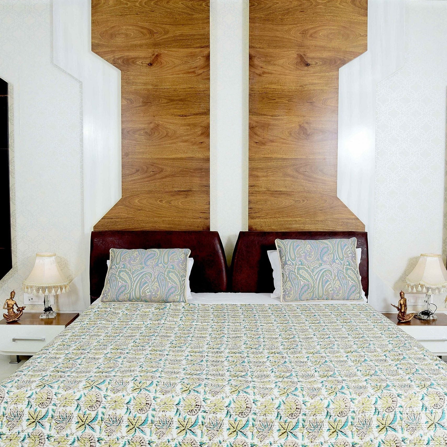 King-size Green Blossom handmade Kantha quilt blanket with floral patterns on a bed with two pillows.