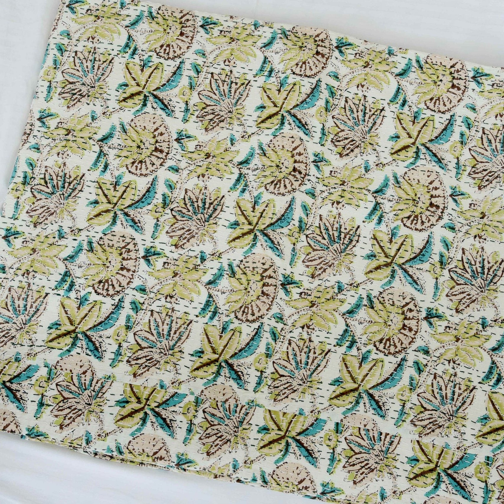 King size Green Blossom handmade Kantha quilt with light green, brown, and teal leaf patterns on cotton.
