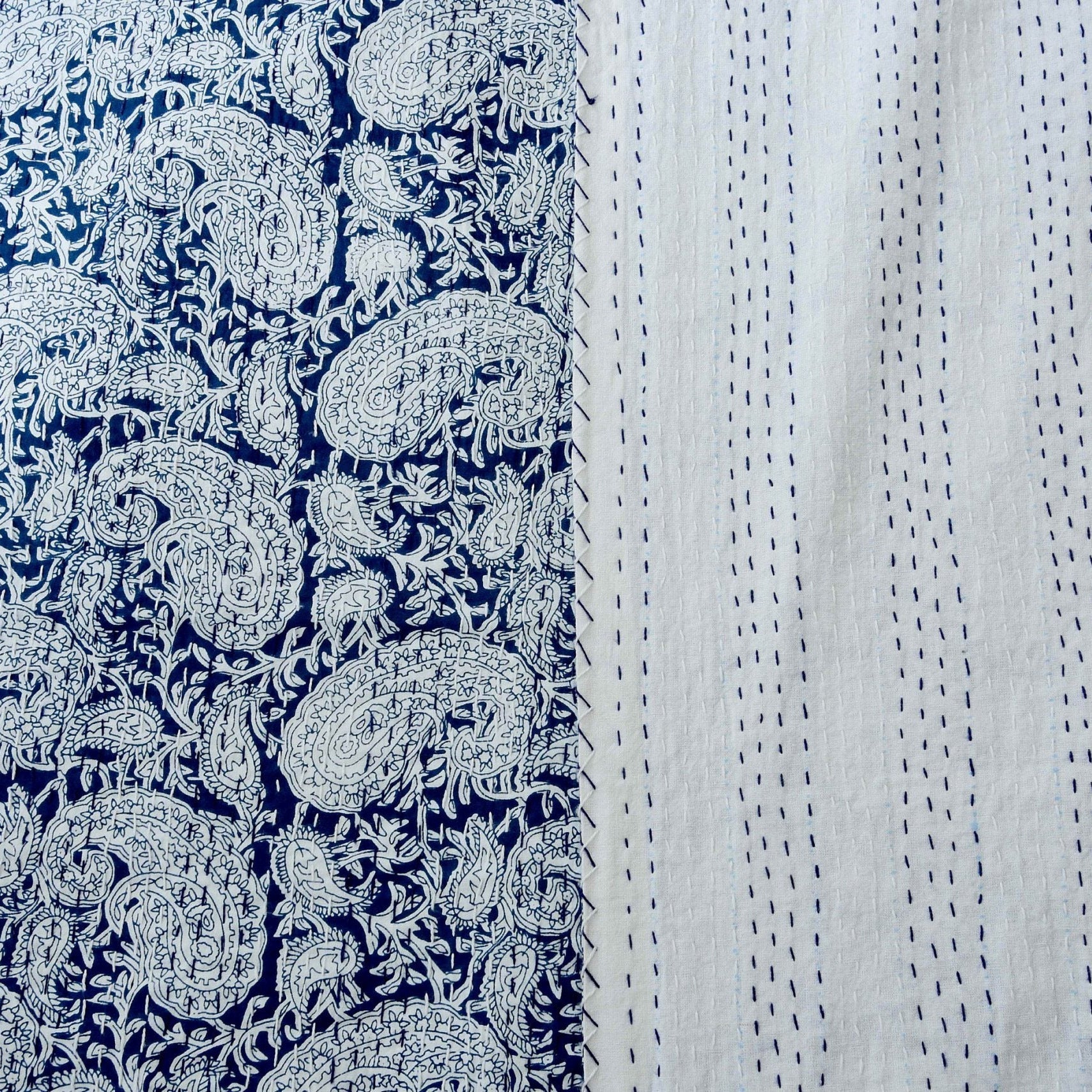Reversible Celestial Blue Kantha Quilt with white paisley pattern and hand-stitched plain white cotton.