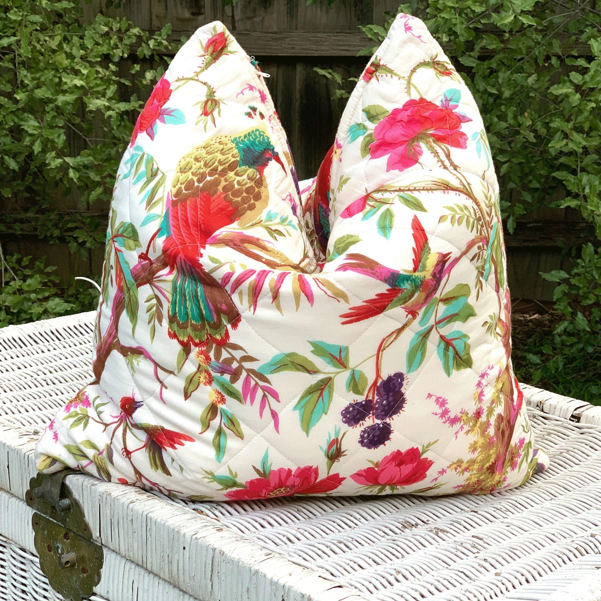 Handmade quilted cotton cushion cover with colorful bird of paradise and floral design on a white background.