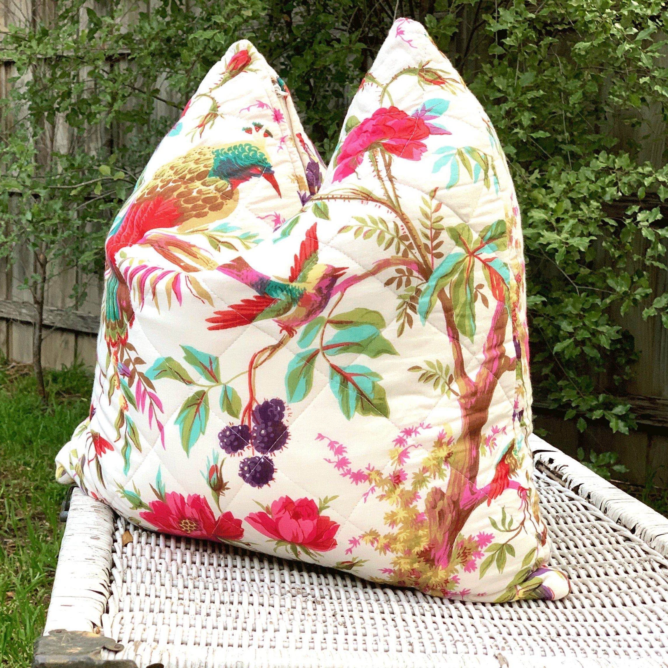 Handmade quilted cotton cushion cover with colorful bird of paradise and floral design on a white background.