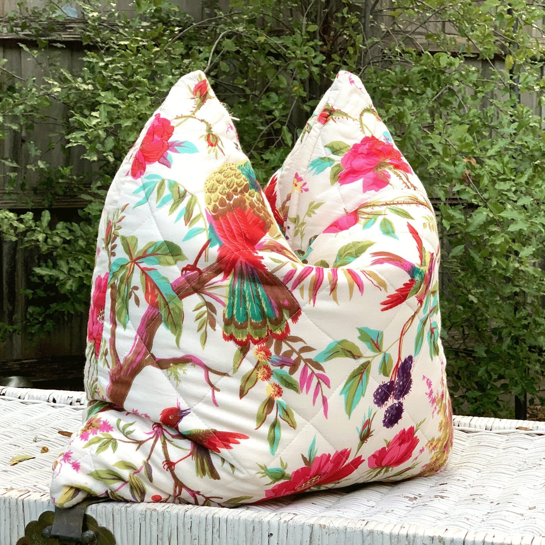 Handmade quilted white cotton cushion cover with vibrant floral and bird of paradise design.