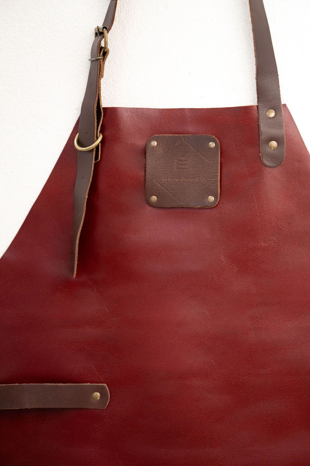 Handcrafted red leather apron minimal style with strong stitching