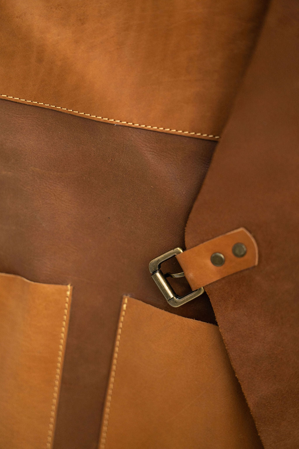 Minimalist tan leather work apron with pockets for barbers and makers