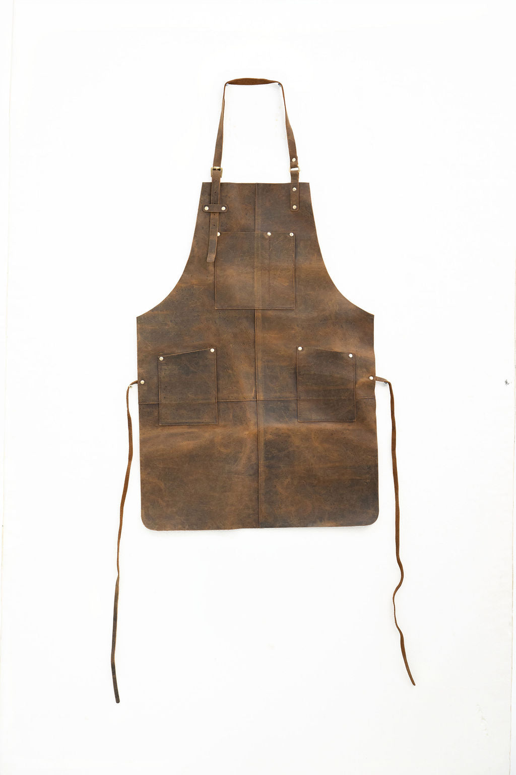Durable brown leather work apron with pockets for workshop use