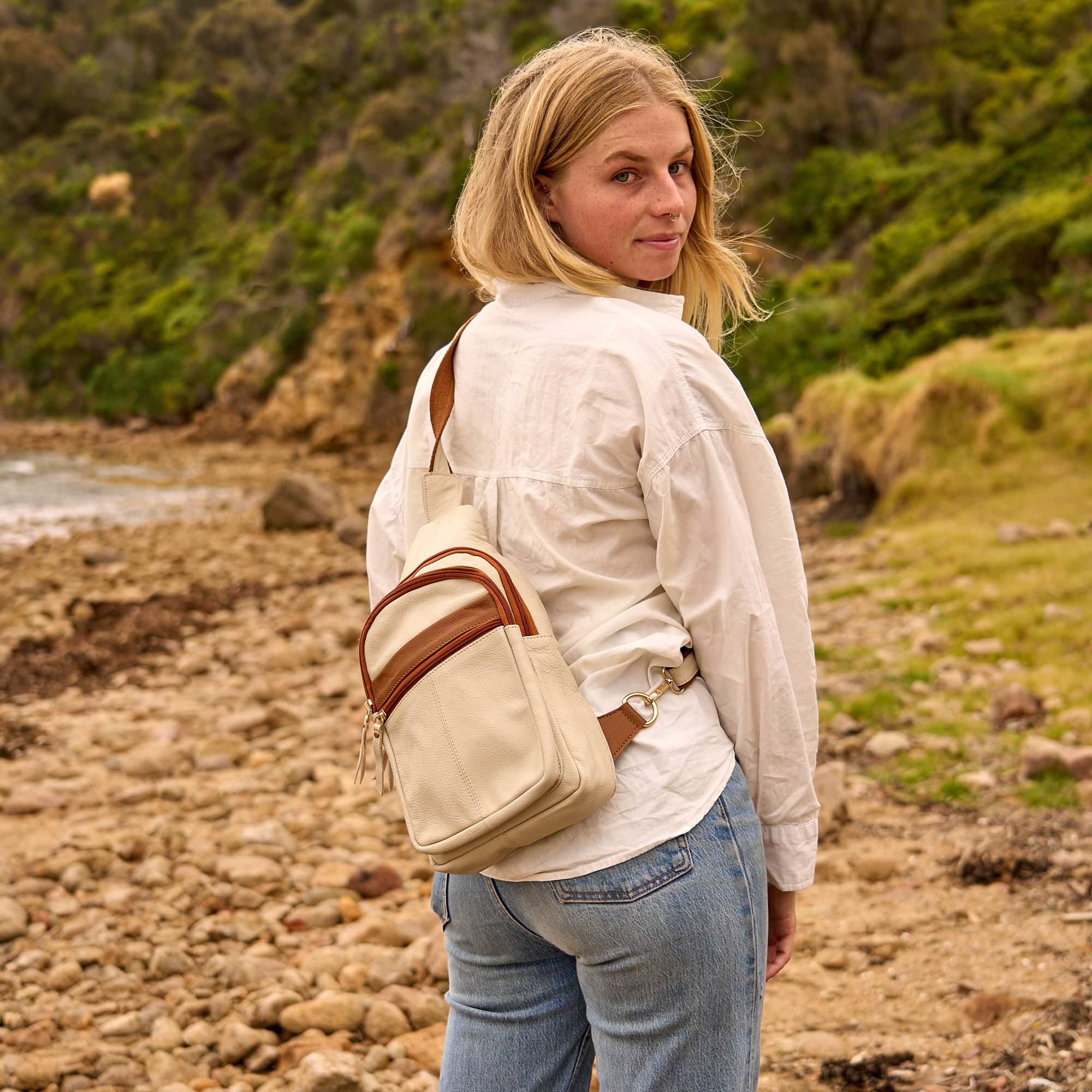 Genuine leather travel crossbody bag for women featuring an adjustable shoulder strap and secure zip closure