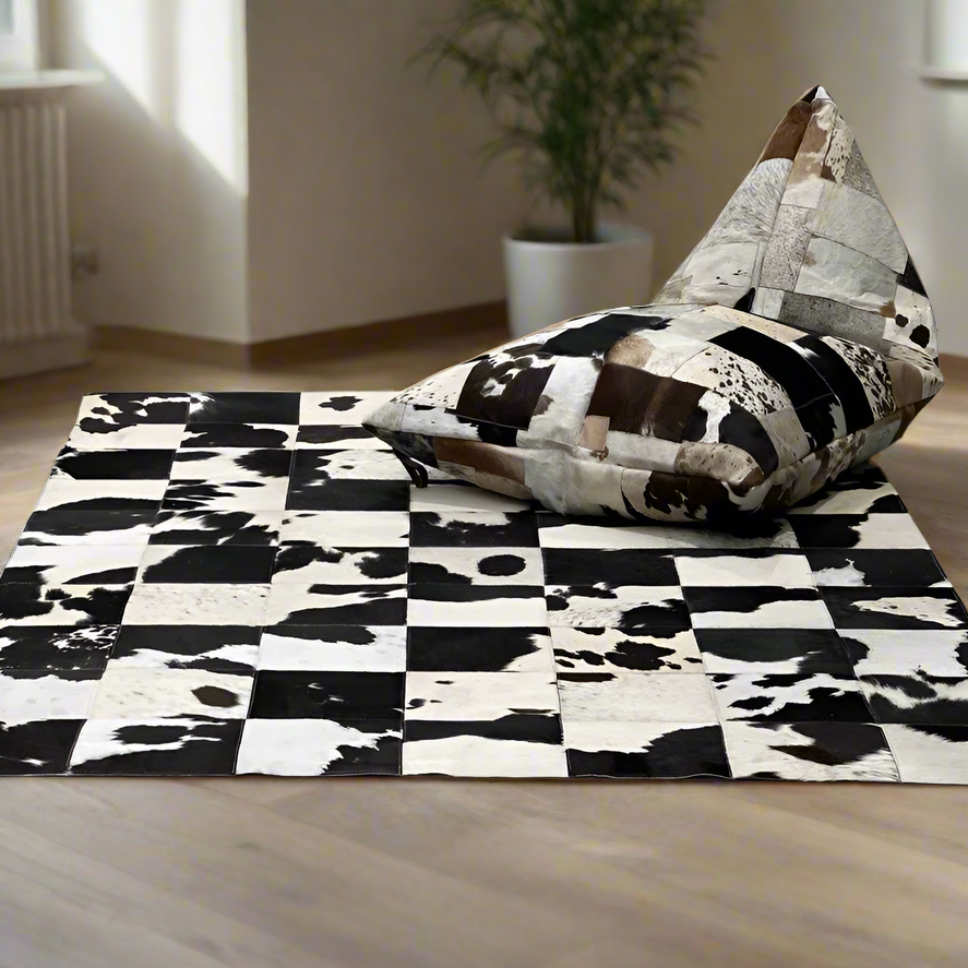 Boho cowhide bean bag cover with triangular patchwork in cream, coffee, chocolate, and brindle tones, on a matching rug.