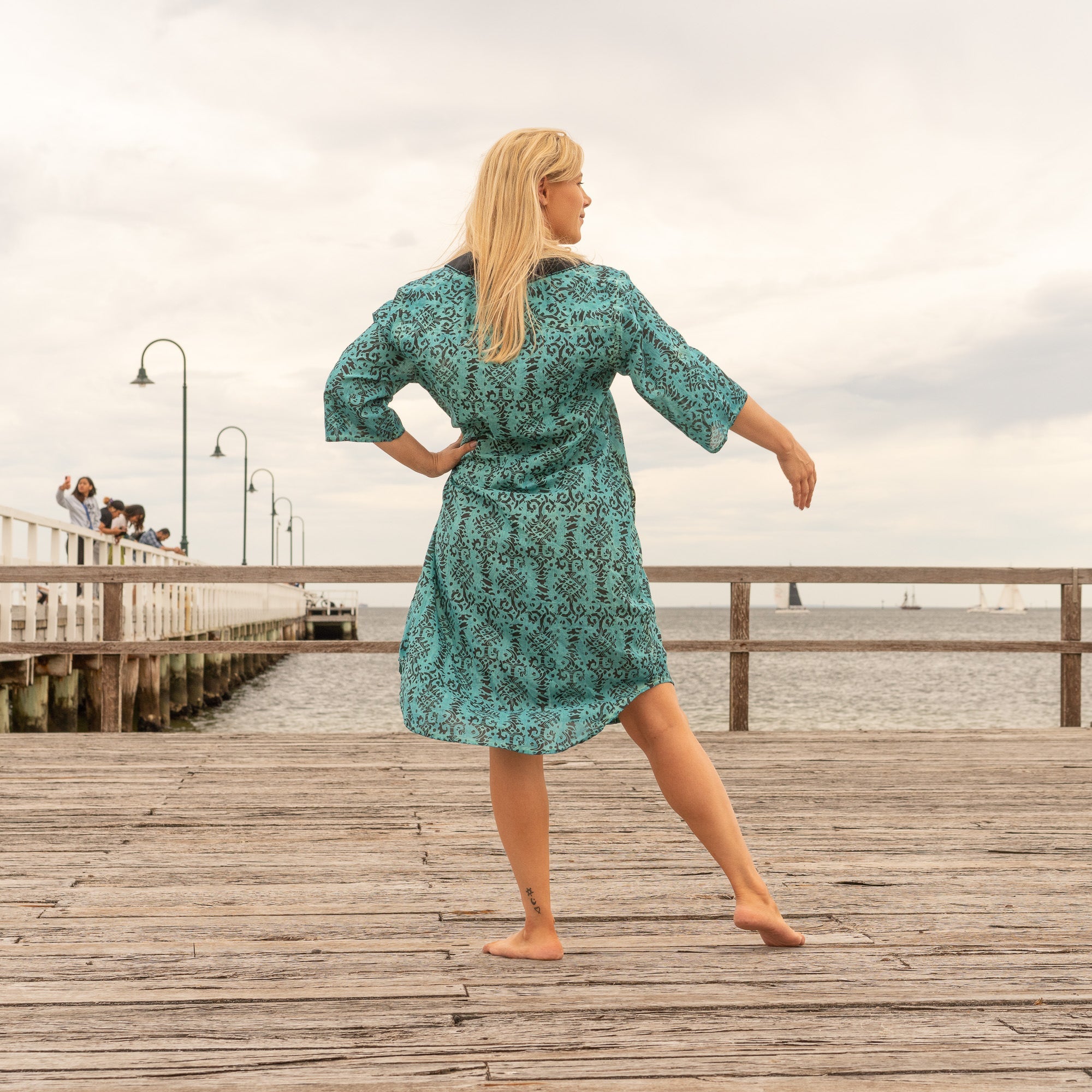 Close-up of handcrafted detailing and fabric texture on teal shirt dress