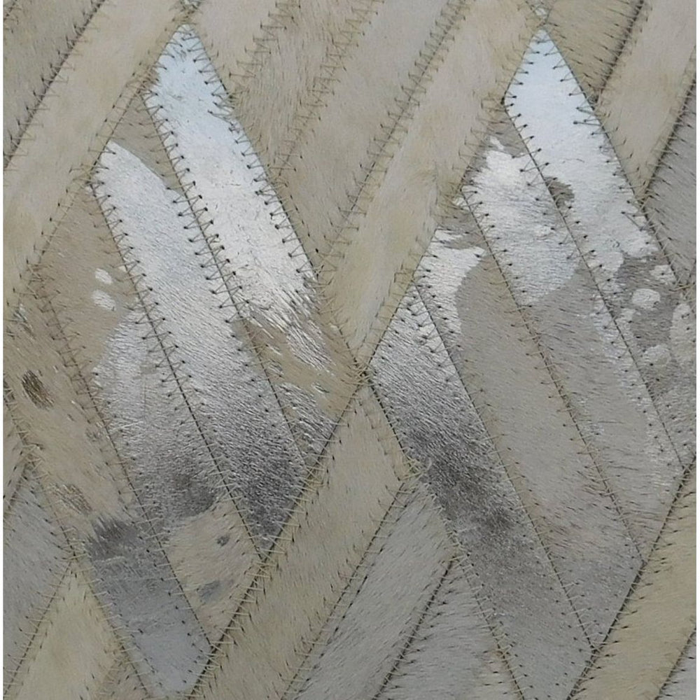 Ivory cowhide leather cushion cover with silver patchwork in a diagonal pattern.