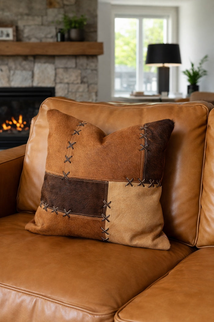 Boho cowhide leather cushion cover in tan and chocolate tones 45x45cm on sofa