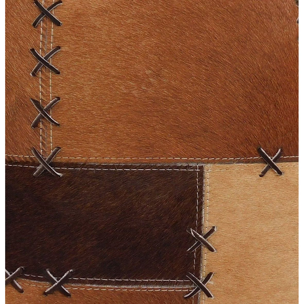 Tan & chocolate cowhide patchwork cushion cover with rustic cross-stitch lacing.
