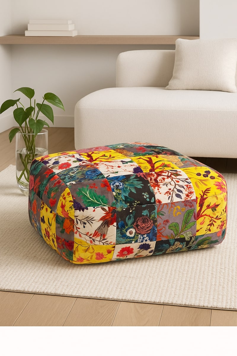 Bohemian floral velvet patchwork pouf styled in a cozy modern living room corner