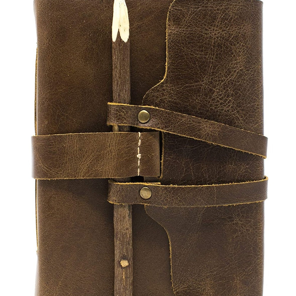 Vintage brown genuine leather journal with a rustic stick and leather strap closure.